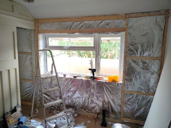 A photo showing internal wall insulation being installed