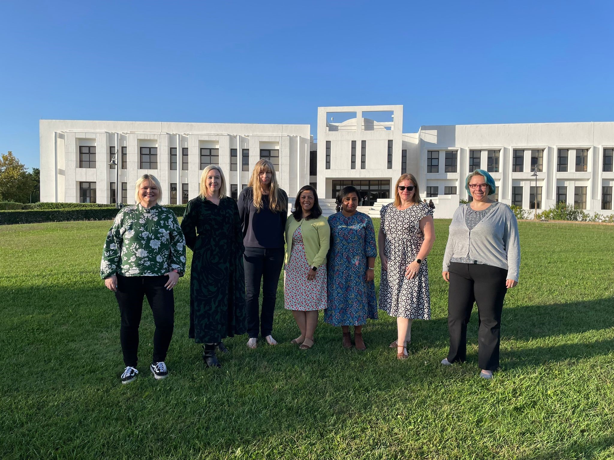 Babraham Institute members stood outside a modern building in the sunshine