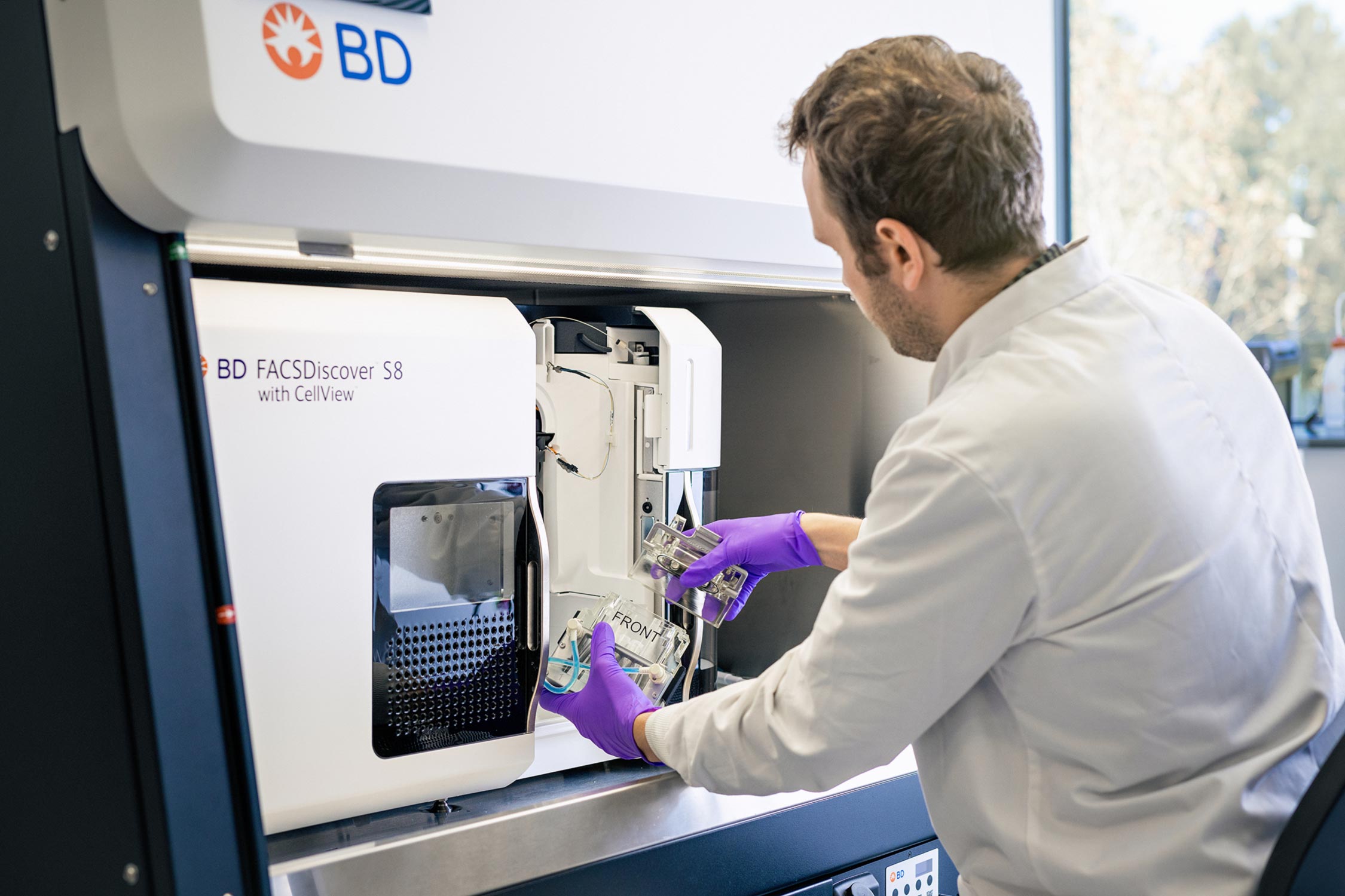 A technical expert prepares an instrument for use in the Flow Cytometry facility.