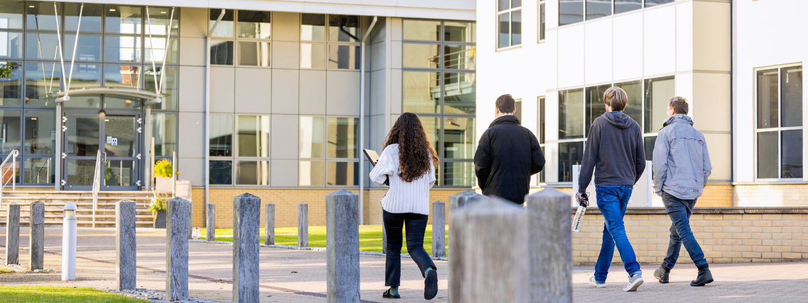 Group of four people walking back towards the Babraham Institute labs
