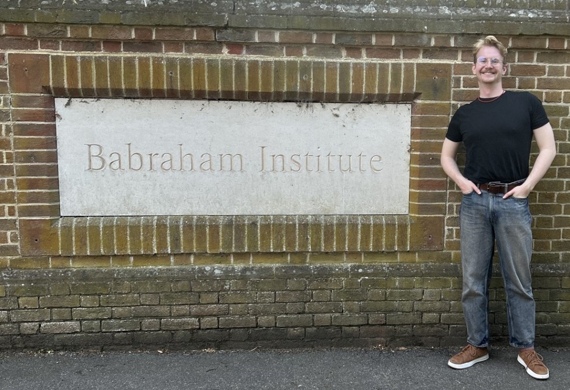 Tomasz stood next to the Babraham institute sign